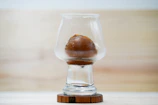 Artistic shot of a single cork coaster under glass with soft natural lighting.