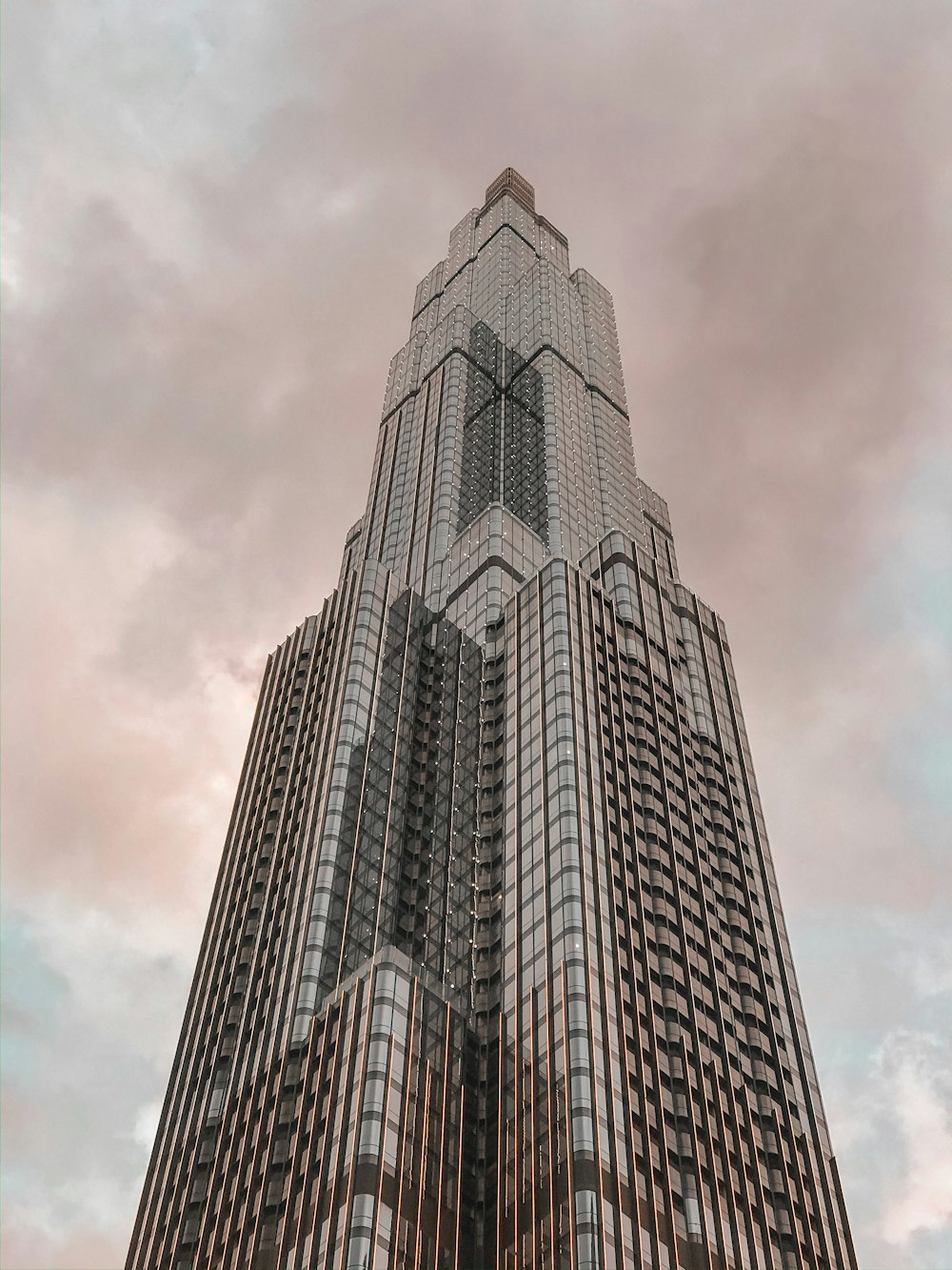 gray concrete building under white clouds during daytime