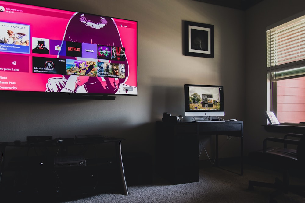 black flat screen tv turned on near black wooden table