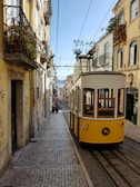 yellow and white tram on street during daytime