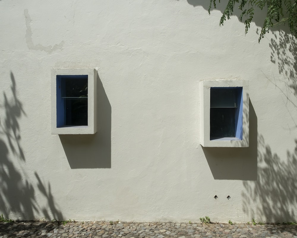 blue wooden window on white concrete wall