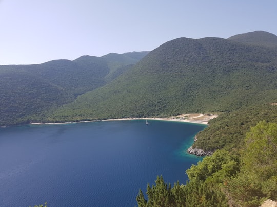 green mountains near body of water during daytime in Antisamos Beach Greece