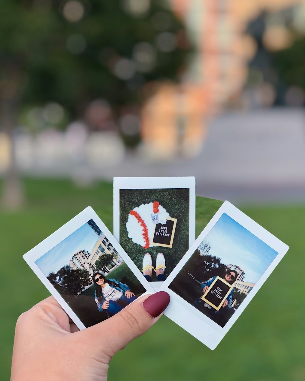 person holding 2 photos of 2 women