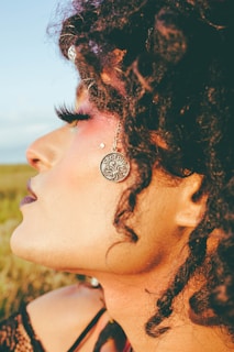 woman with black hair and silver stud earrings