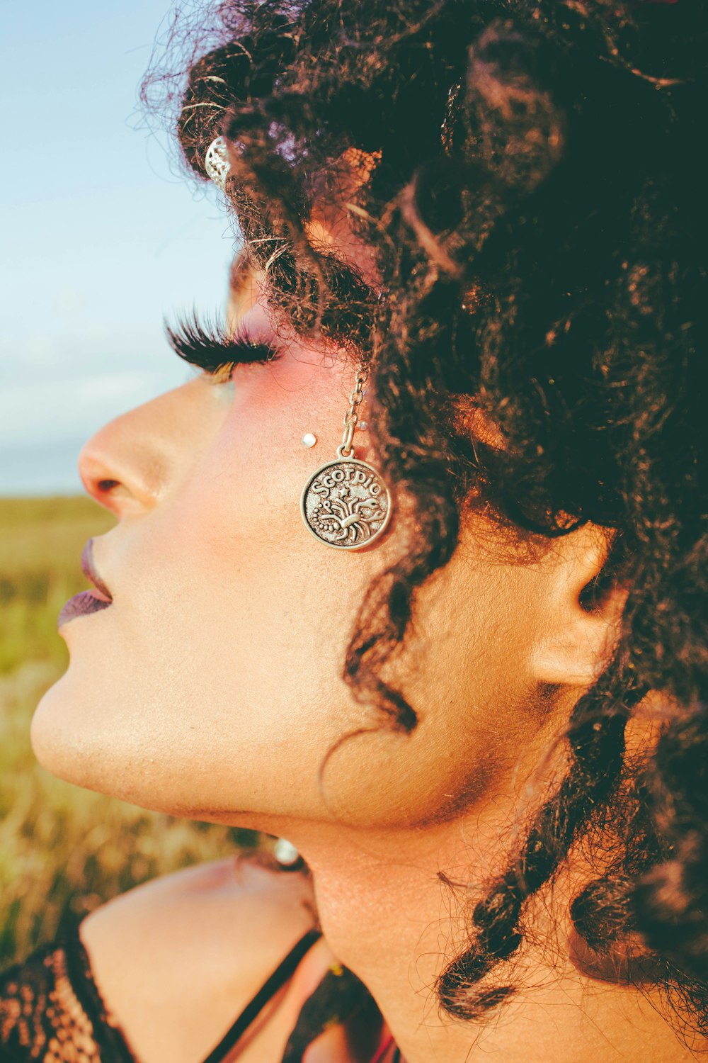 woman with black hair and silver stud earrings