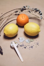 yellow lemon fruit beside silver fork on white and blue floral textile