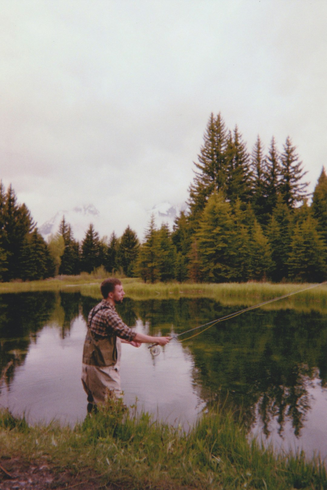 man fishing on lake during daytime
