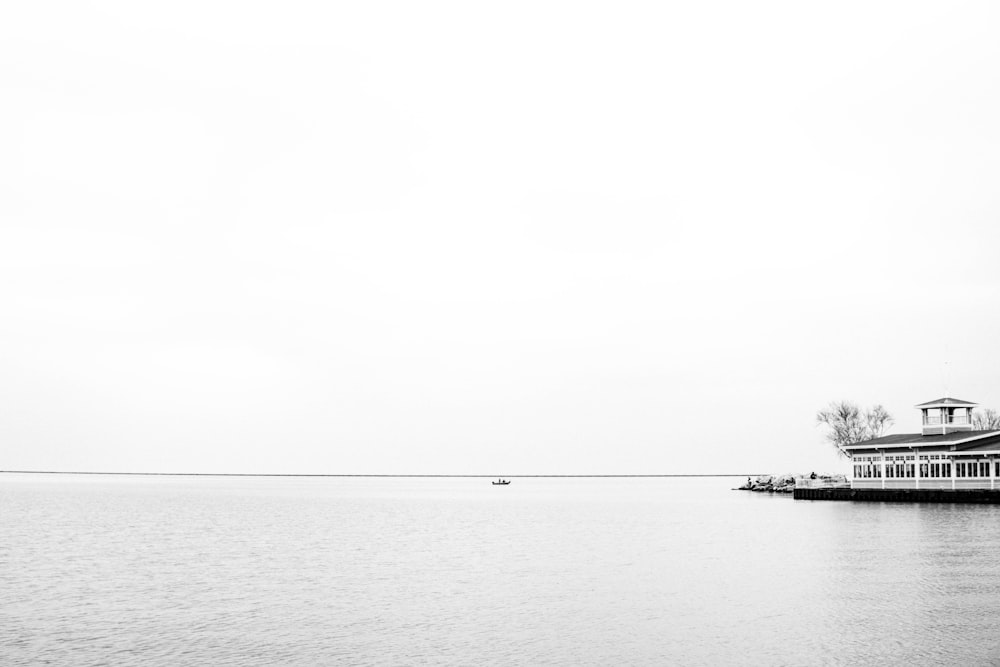 boat on sea under white sky during daytime