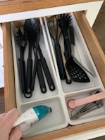 A domestic worker organizing kitchen utensils neatly