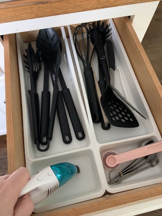 Adjustable drawer dividers keeping kitchen utensils perfectly separated.