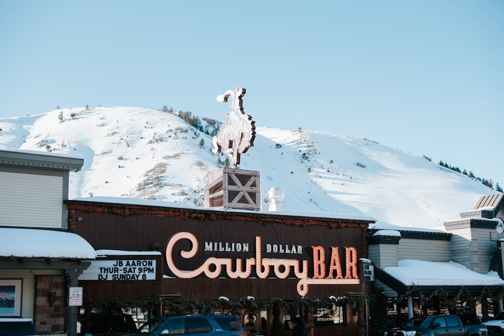 brown and white wooden building on snow covered mountain during daytime