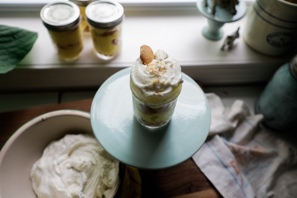 white and brown ice cream on white ceramic bowl