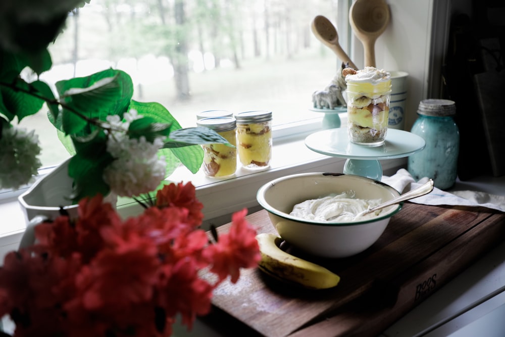 white ceramic bowl on brown wooden chopping board