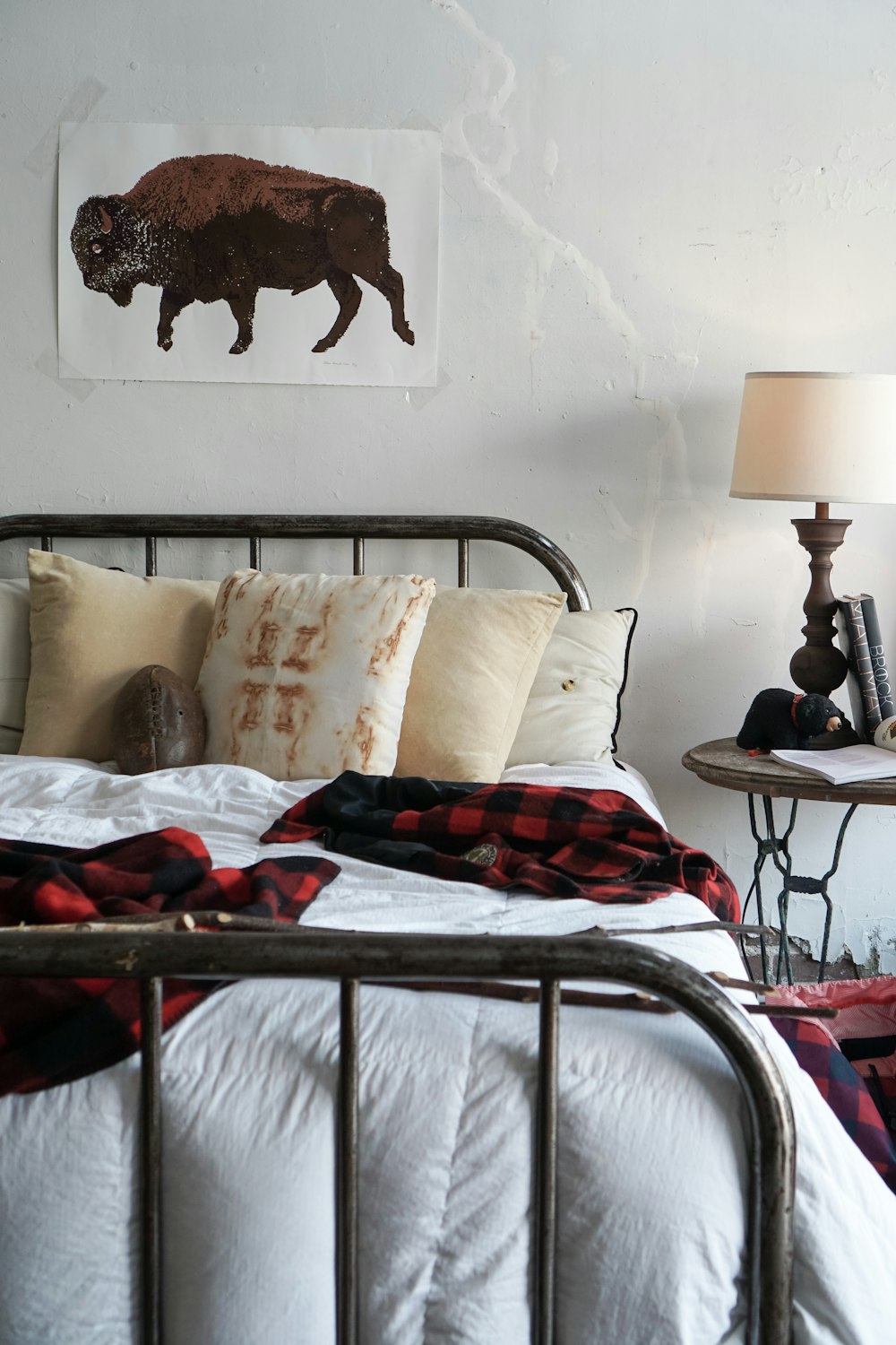 white pillow on bed beside black table lamp