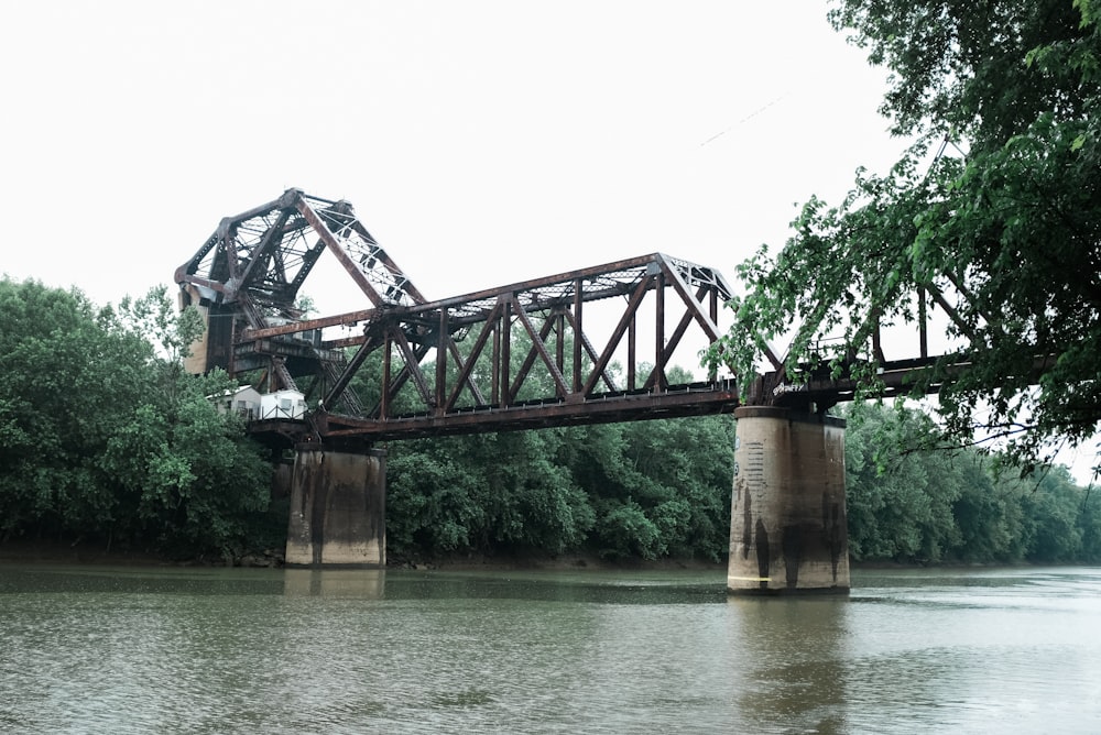 brown concrete bridge over river during daytime
