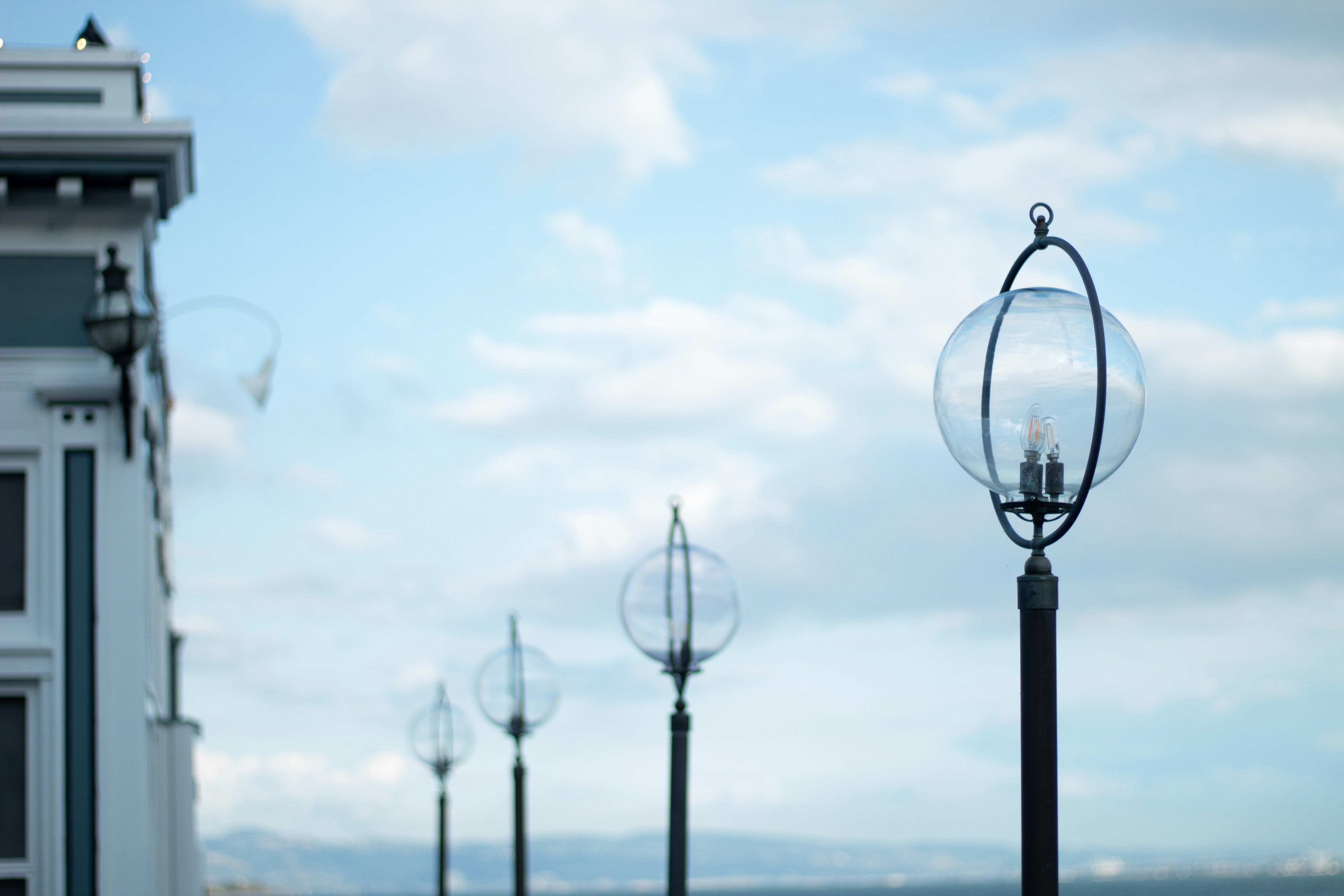 black street light near sea during daytime