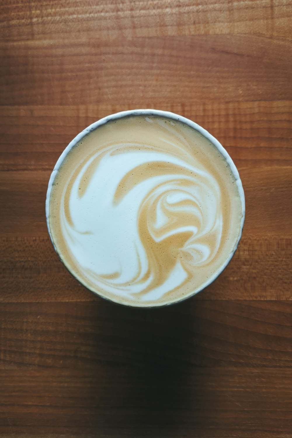 white ceramic cup with brown and white liquid