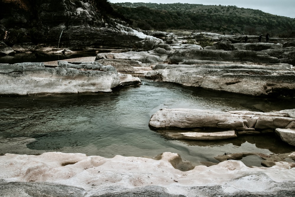 brown rock formation on river during daytime