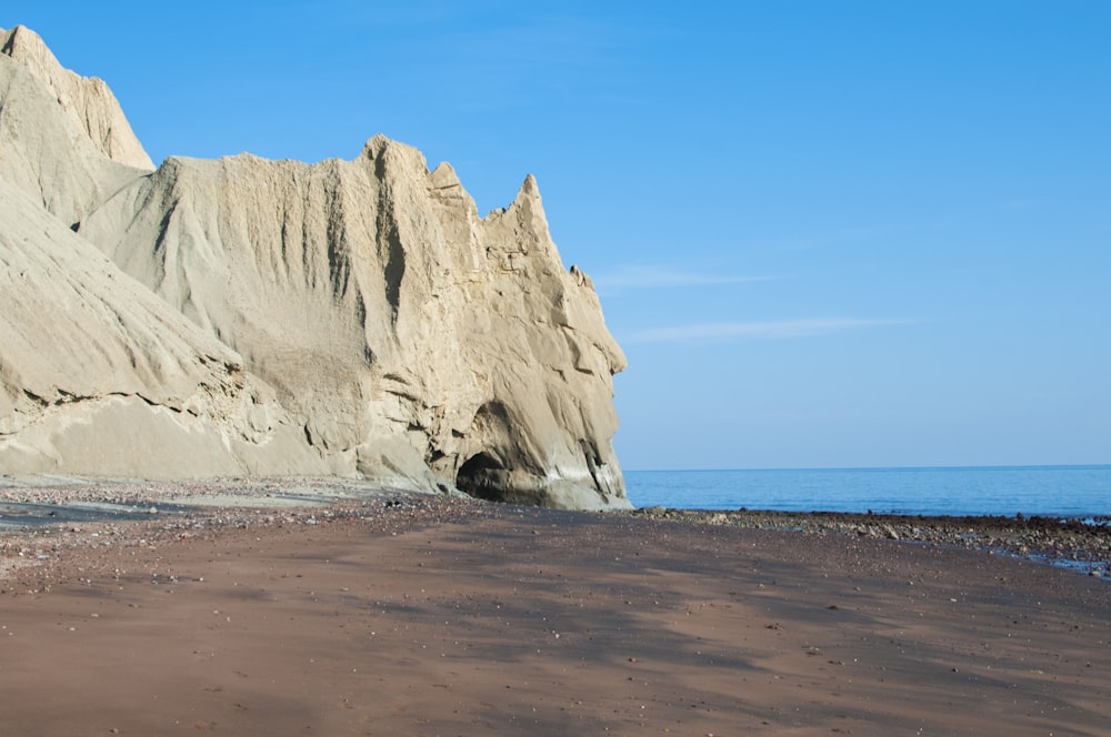 brown rock formation on sea shore during daytime