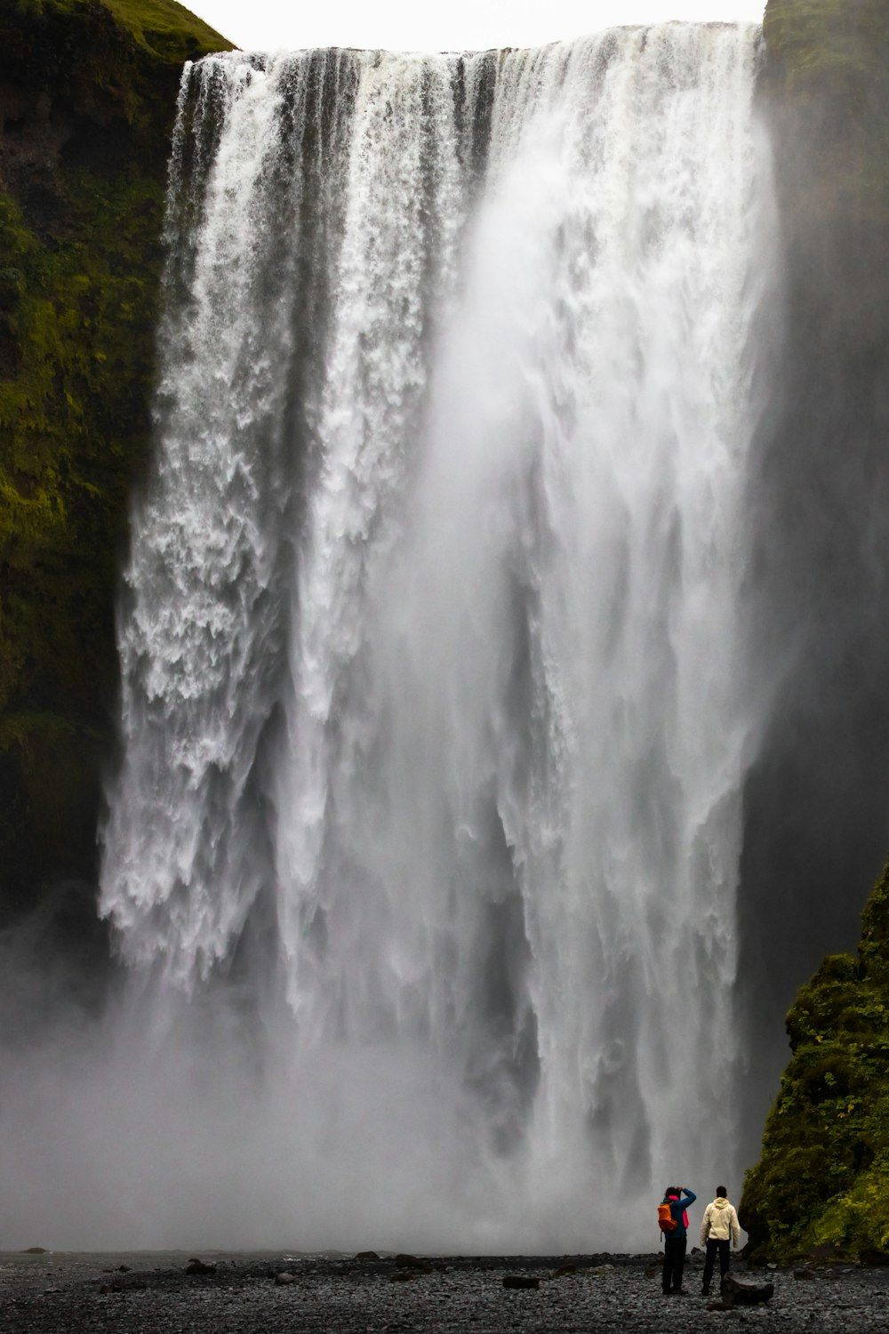 waterfalls on brown rocky mountain during daytime