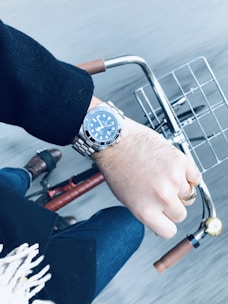 person wearing black and silver chronograph watch