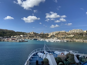 A serene harbor view with boats docked and a clear blue sky.