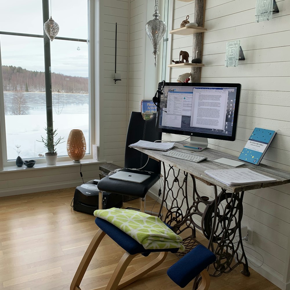 black laptop computer on brown wooden table