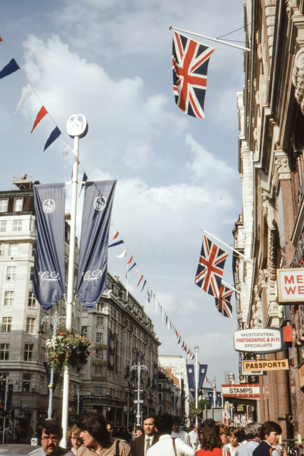 flags on poles on street during daytime