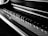 A close-up view of a piano keyboard highlighting the alternating pattern of black and white keys, with light reflecting off the polished surface.