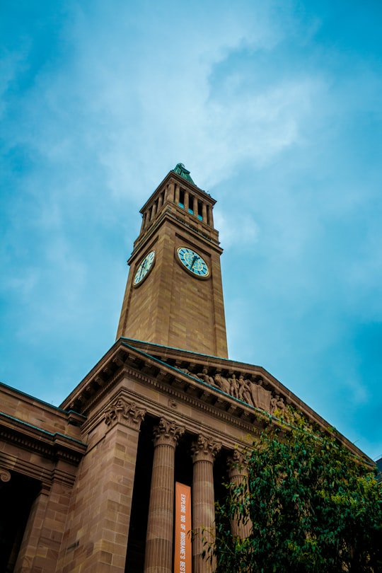 brown concrete building under white clouds during daytime in Brisbane City Hall Australia