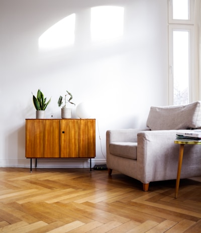 brown wooden table beside gray couch