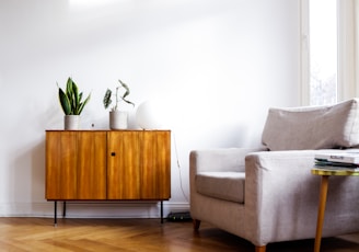 brown wooden table beside gray couch