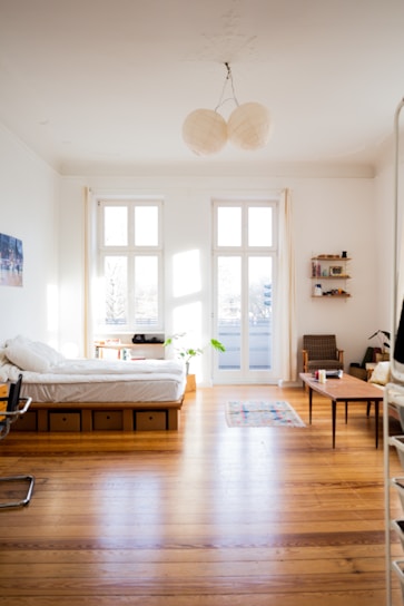 Bright and tidy Normal Room with simple wooden furniture and soft natural light.