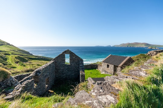 brown brick house near body of water during daytime in County Kerry Ireland