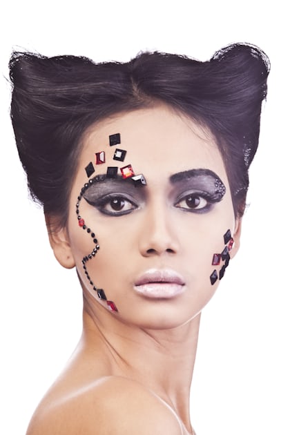 Premium Photo  A woman with black face paint and red dots