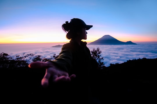 man in black hat and brown jacket in Dieng Indonesia