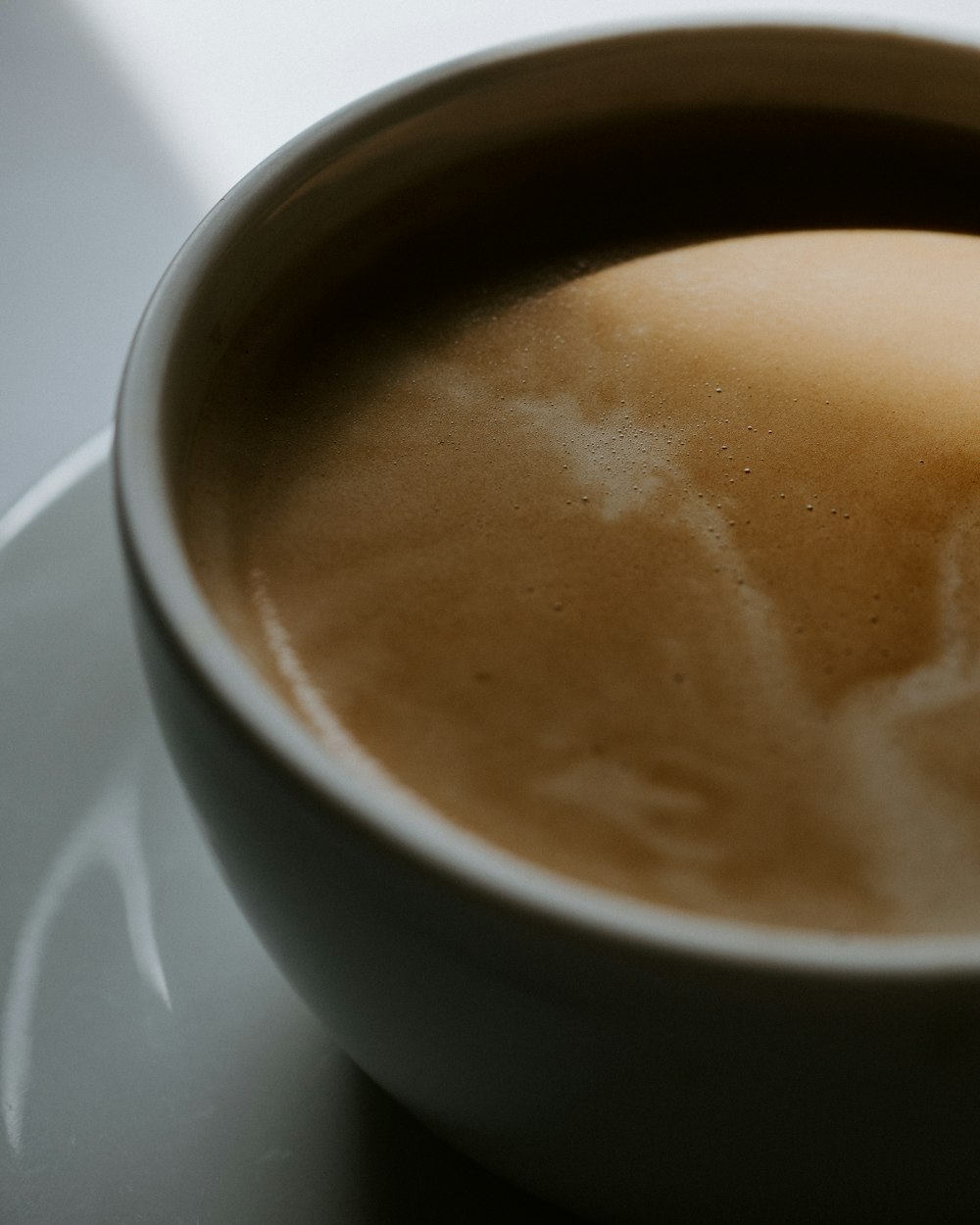 white ceramic cup with brown liquid