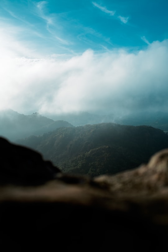 mountains under white clouds and blue sky during daytime in Mount Marami Philippines