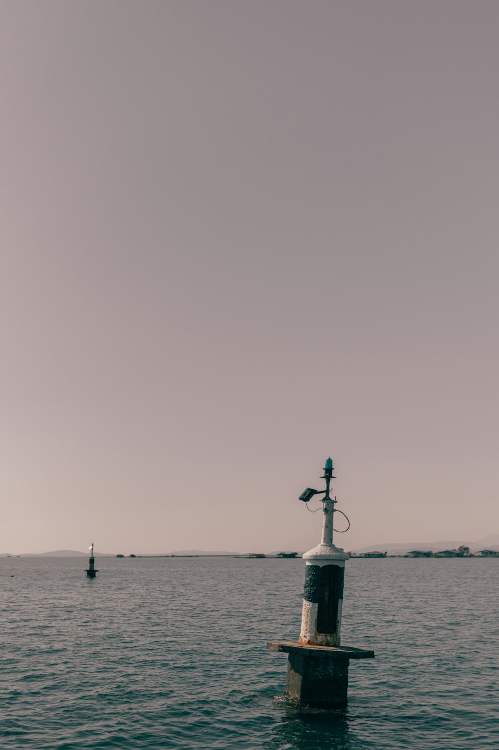 a light pole in the middle of a body of water