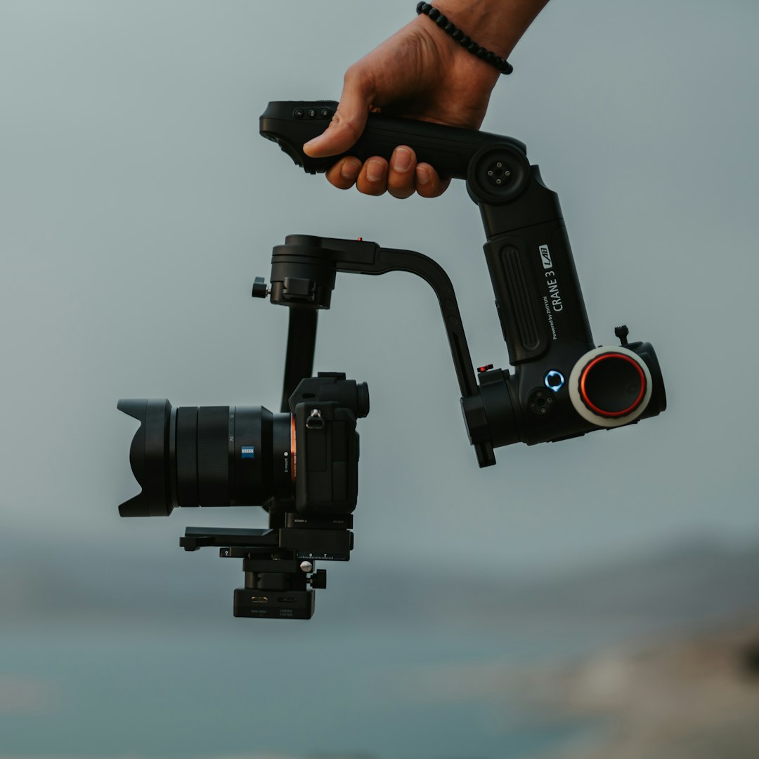 person holding black dslr camera