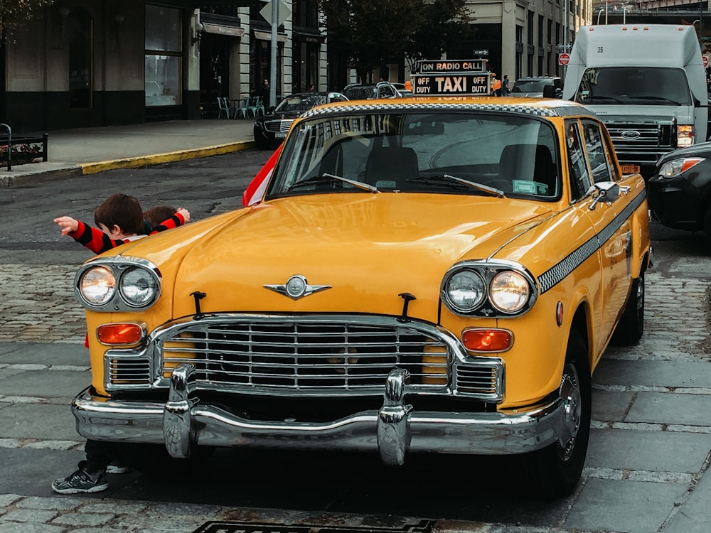 yellow classic car on road during daytime