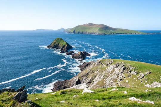 green and brown mountain beside sea during daytime in County Kerry Ireland