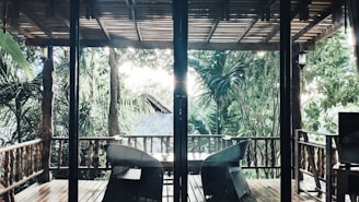 A cozy, sunlit porch overlooking lush greenery and a serene river in rural Florida.