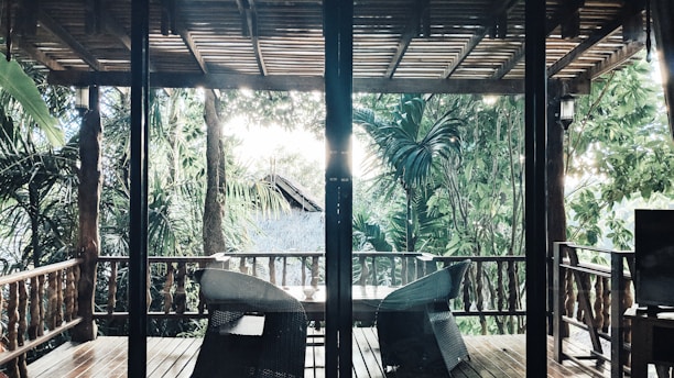 Sunlit porch overlooking lush greenery at Hilton Head A & B Gannet St.