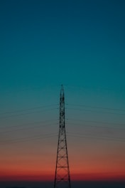 black electric tower under blue sky during daytime