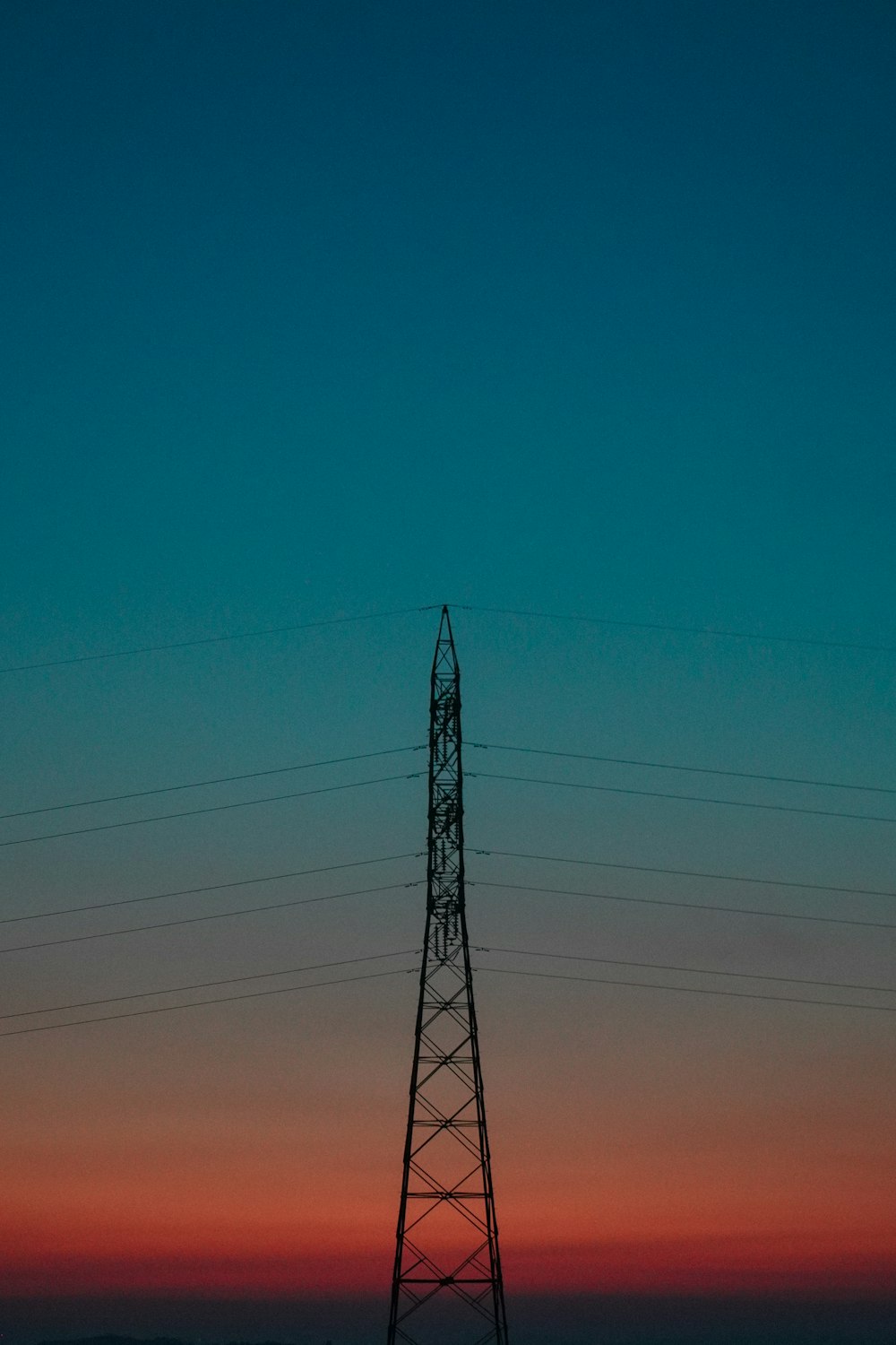 black electric tower under blue sky during daytime