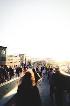 A bustling street scene in Pematangsiantar with locals going about their day under bright sunlight.