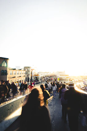 A candid shot of a sunlit street scene with vibrant colors and lively shadows.
