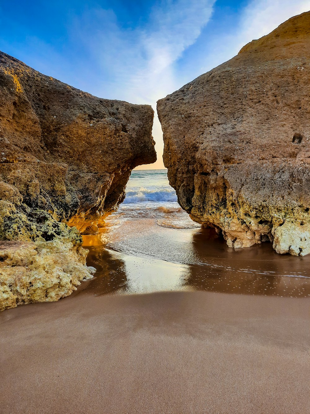 brown rock formation on body of water during daytime