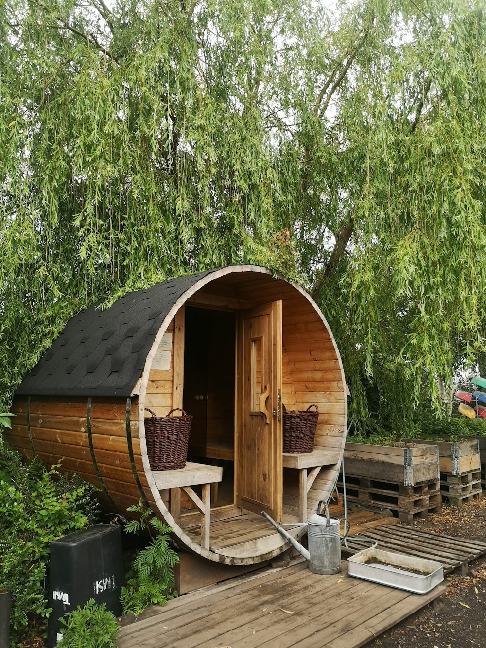 brown wooden shed near green trees during daytime